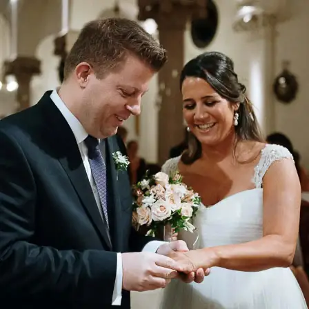Smiling bride and groom exchanging wedding rings at the altar during their marriage ceremony in Buenos Aires.
